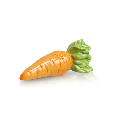Ceramic carrot with green stem on white background