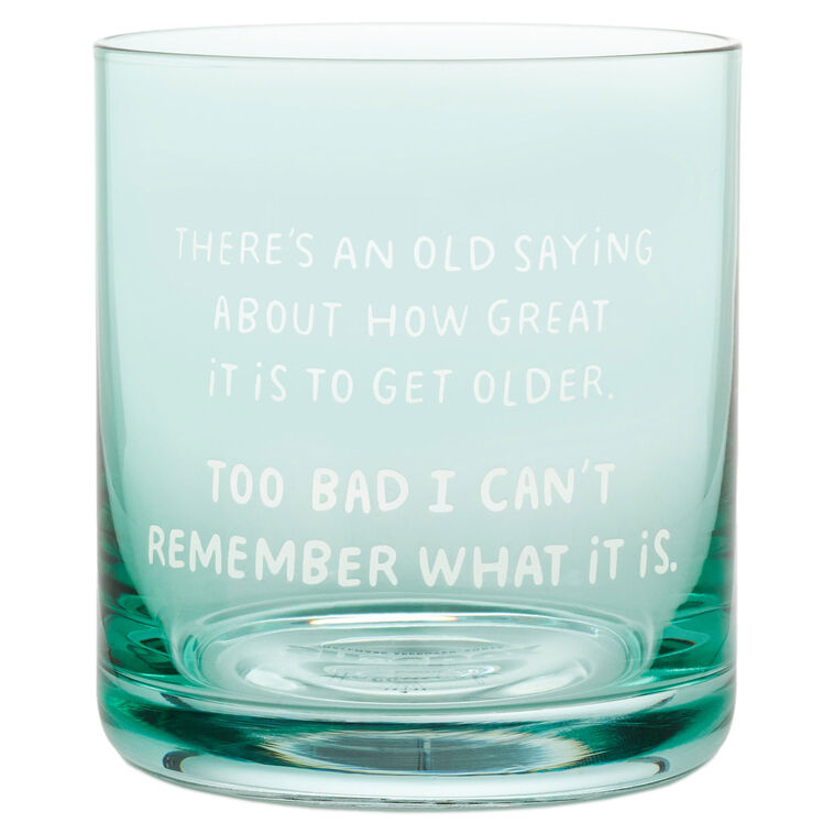 Green-tinted rocks glass with white text: “There&