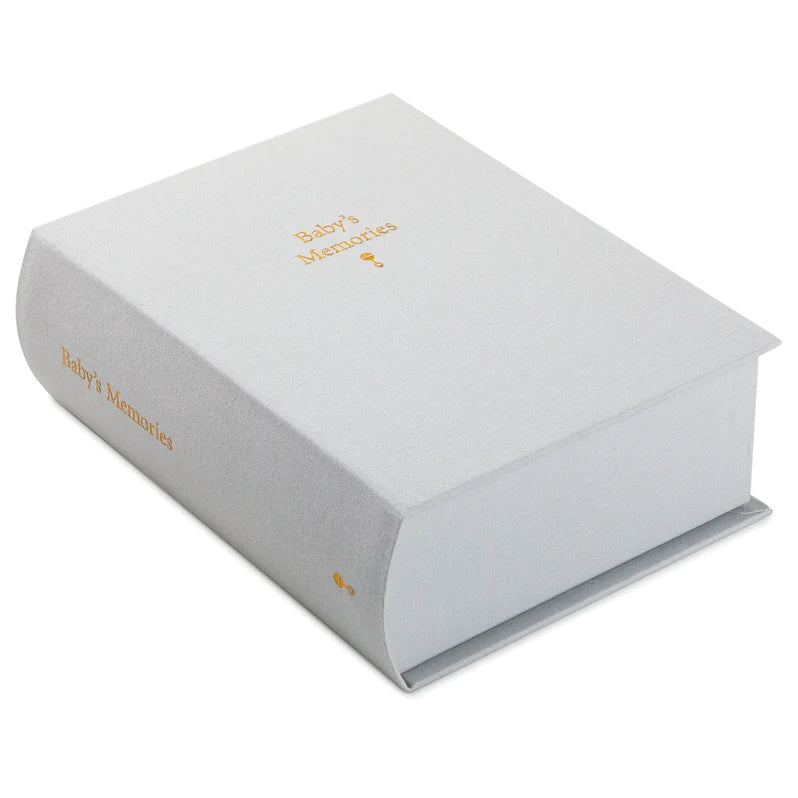 Gray fabric-covered baby memory box with gold foil “Baby’s Memories” lettering and magnetic clasp closure.