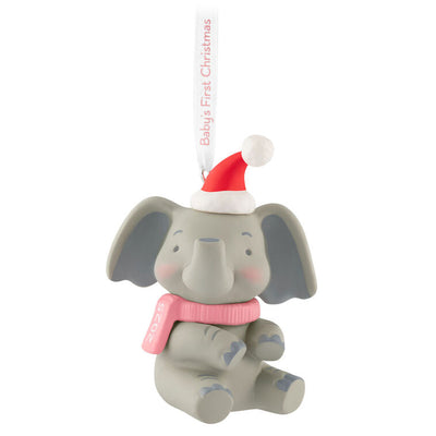 Gray elephant ornament in Santa hat and pink scarf holds a “Baby’s First Christmas 2025” ribbon.