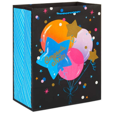 Hallmark medium graduation gift bag with colorful balloon bouquet, gold confetti accents, and "Congrats Grad!" message.

