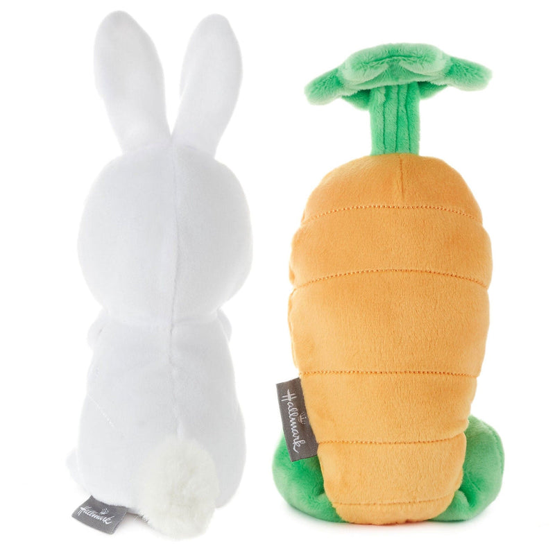 White rabbit and carrot plush toys on white background