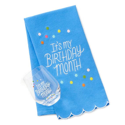 Hallmark birthday month gift set with blue embroidered tea towel and coordinating stemless wine glass, perfect for milestone 
