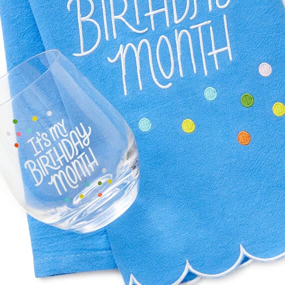 Hallmark birthday month gift set with blue embroidered tea towel and coordinating stemless wine glass, perfect for milestone 
