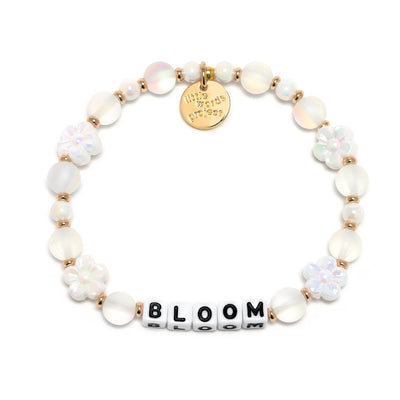M/L hand-crafted daisy-inspired bracelet with crystal beads and Bloom letter beads, featuring plated brass and elastic stretch fit.

