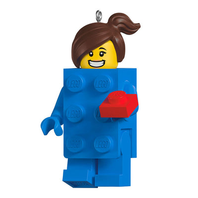 LEGO minifigure ornament with blue brick body, red piece in hand, and smiling brunette girl face.