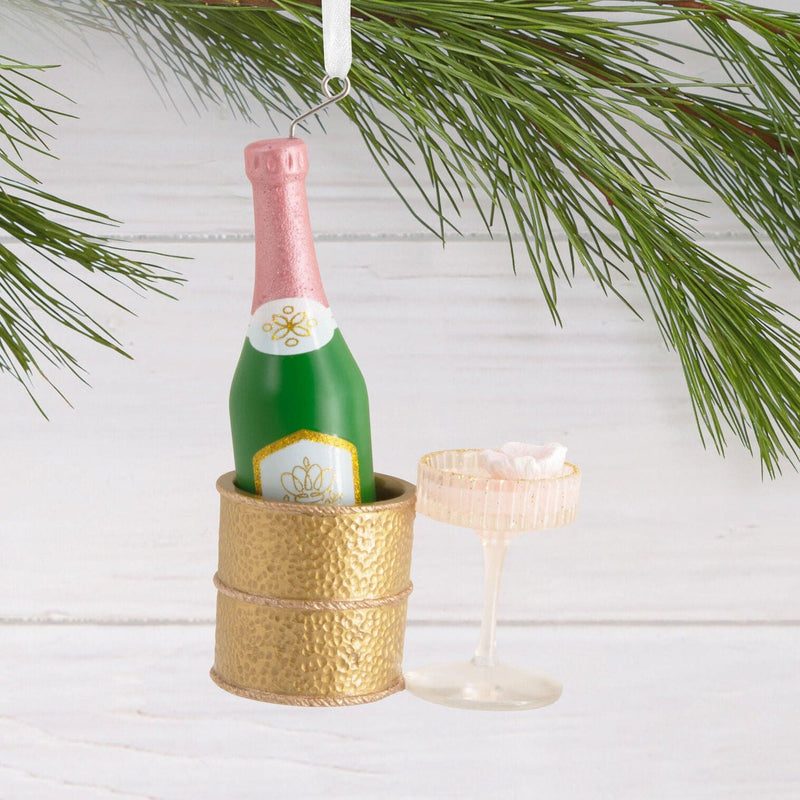 Hallmark ornament with champagne bottle in gold chiller and coupe glass
