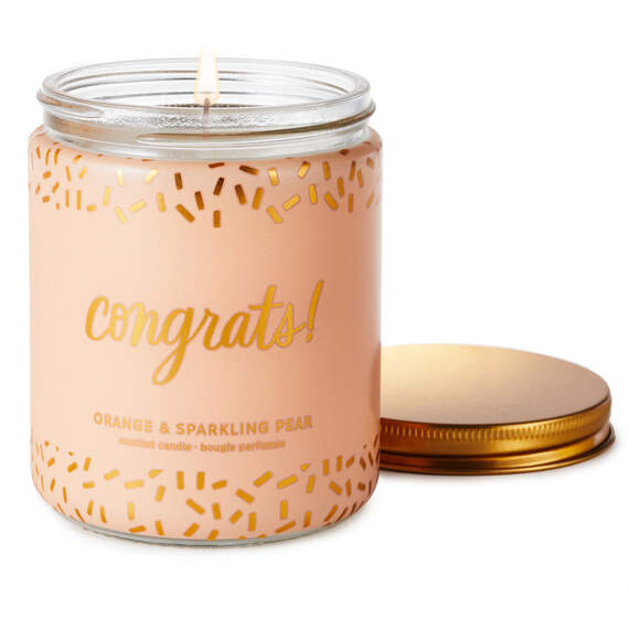 Festive Hallmark single-wick candle with orange and pear scent, coral confetti design, and “Congrats!” message.


