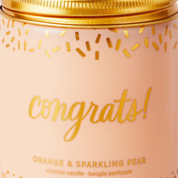 Festive Hallmark single-wick candle with orange and pear scent, coral confetti design, and “Congrats!” message.

