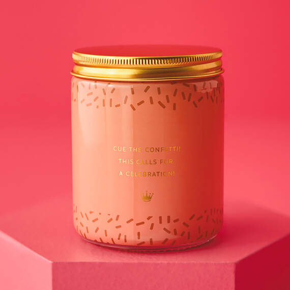 Festive Hallmark single-wick candle with orange and pear scent, coral confetti design, and “Congrats!” message.

