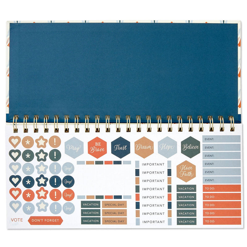 Spiral-bound weekly calendar with uplifting “This Is the Day” scripture theme and floral design for desk or tabletop use.

