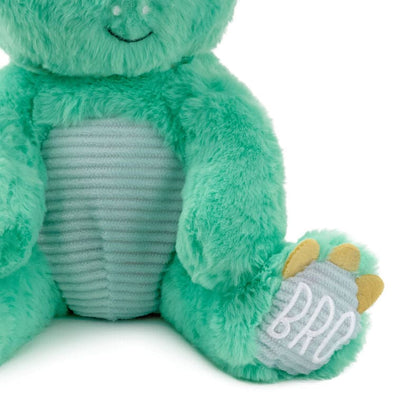 Big Brother dinosaur plush in bright green with blue corduroy accents and “Big Bro” stitched on its feet