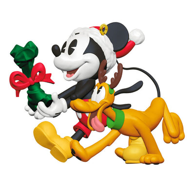 Mickey Mouse holding a dog bone gift walks beside Pluto in reindeer antlers in this cheerful Disney Hallmark Christmas ornament.