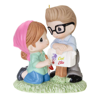 Porcelain ornament of Carl and Ellie from Disney Pixar’s Up painting a mailbox, in Precious Moments style