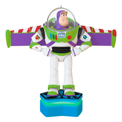 Buzz Lightyear Christmas ornament with wings extended on blue base, featuring light and sound effects