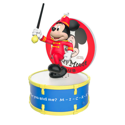 Mickey Mouse as bandleader in red outfit conducts with baton on drum stage in this musical Disney Christmas ornament with light.