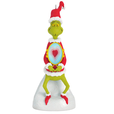 Grinch ornament in Santa suit standing on snow with heart-shaped lenticular chest image