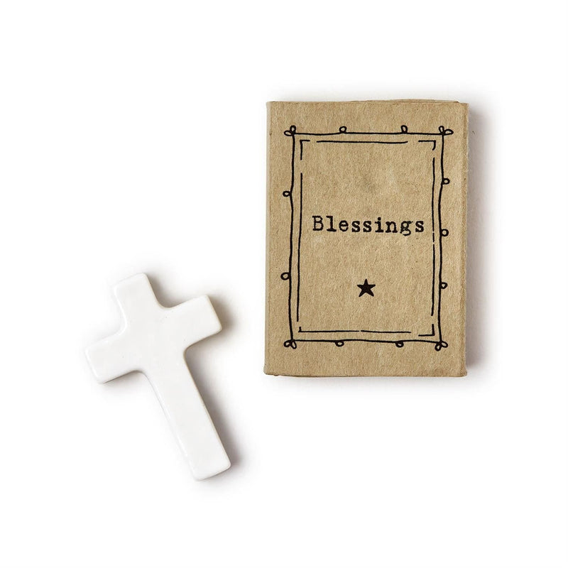 Porcelain miniature cross in a matchbox with "Blessings" on the front.