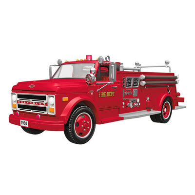 1968 red Chevrolet fire engine Christmas ornament with ladder details, turning wheels, and battery-powered light on front grill.