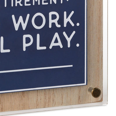 Square retirement wall decor with "No work, all play" message in white on layered blue wood and clear acrylic   6.5 inches.