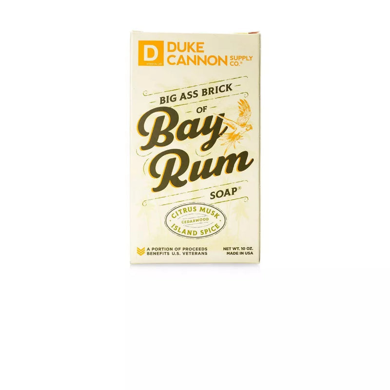 Brown bar of soap with gold lettering "DUKE CANNON" "BIG ASS BRICK OF SOAP" and bay rum leaf.