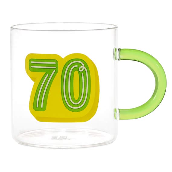 Hallmark glass 70th birthday mug with green and yellow "70" design and green handle, holds 17.5 oz of coffee or tea.

