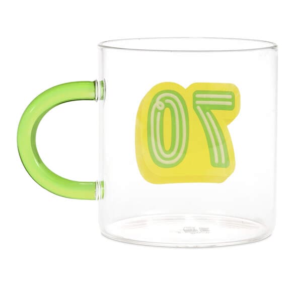 Hallmark glass 70th birthday mug with green and yellow "70" design and green handle, holds 17.5 oz of coffee or tea.

