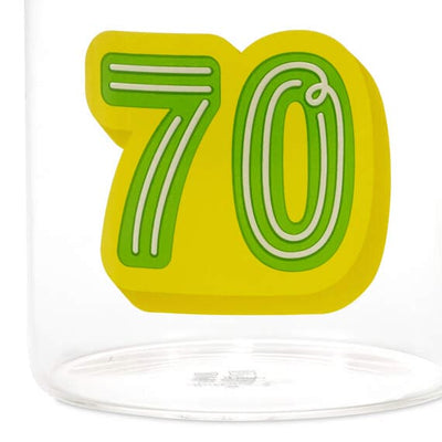Hallmark glass 70th birthday mug with green and yellow "70" design and green handle, holds 17.5 oz of coffee or tea.


