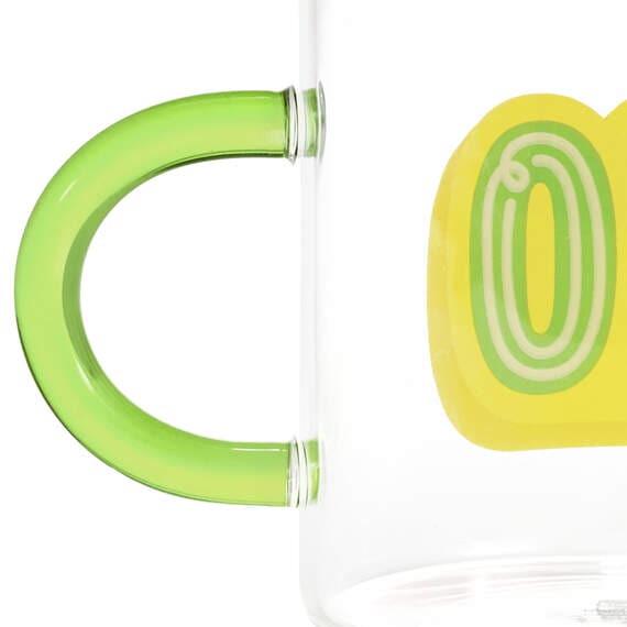Hallmark glass 70th birthday mug with green and yellow "70" design and green handle, holds 17.5 oz of coffee or tea.

