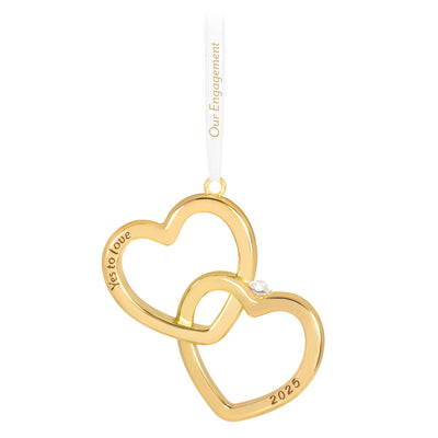Gold interlocking heart ornament with diamond-shaped gemstone and Yes to love sentiment, 2025 engagement design.