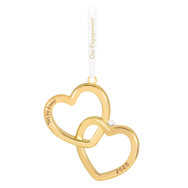 Gold interlocking heart ornament with diamond-shaped gemstone and Yes to love sentiment, 2025 engagement design.