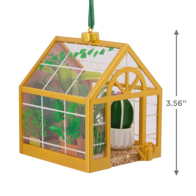 Hallmark greenhouse ornament with potted plants and gold floor
