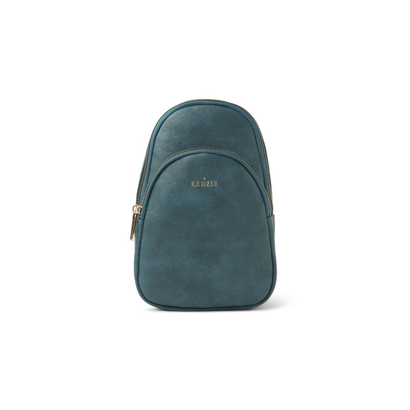 Teal Kedzie Sunset Sling Bag with gold-tone zippers, cheetah print lining, and adjustable 55” strap.

