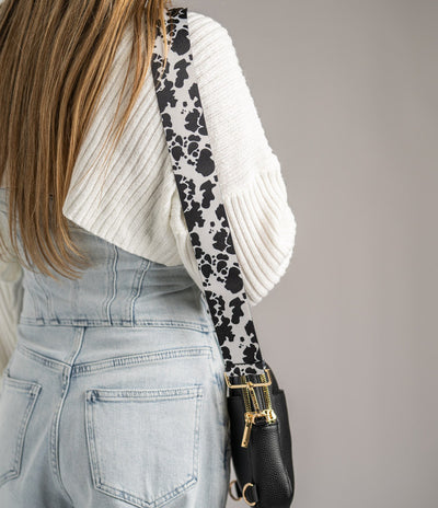 Adjustable shoulder strap in cow print pattern, designed to pair with multiple bags and outfits.