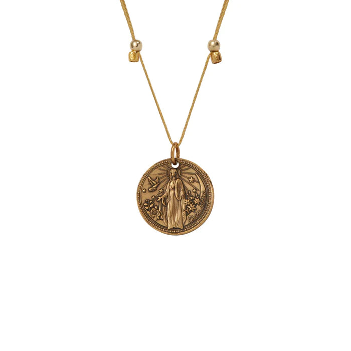 a gold necklace with a medallion of the Virgin Mary,