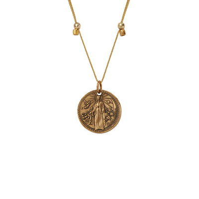 a gold vermeil necklace with a round medallion pendant. The text “Divine Mother” is engraved around the edge of the medallion.