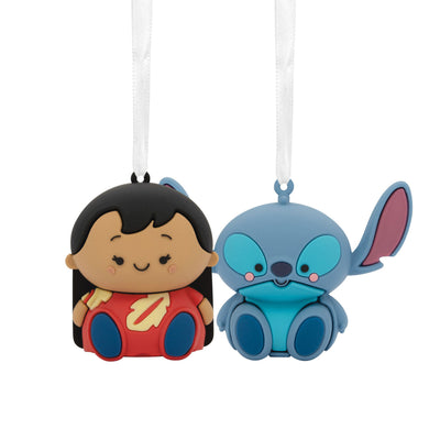 Stitch and Lilo Christmas ornaments. Stitch is a blue alien with large ears and a red and yellow mouth