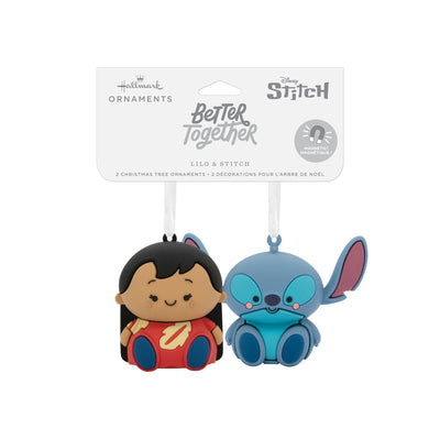 Stitch and Lilo Christmas ornaments. Stitch is a blue alien with large ears and a red and yellow mouth