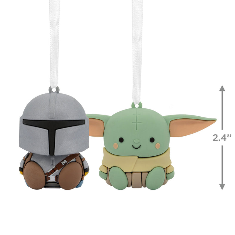 Two Star Wars Christmas ornaments featuring Grogu and a Mandalorian helmet. Grogu is a small, green alien wearing a brown robe. 