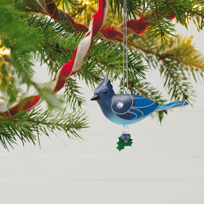 Christmas ornament depicting a bluebird perched on a snowy branch