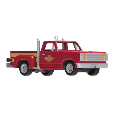 Miniature 1978 Dodge Li’l Red Express Christmas ornament in red and yellow with chrome stacks and turning wheels.