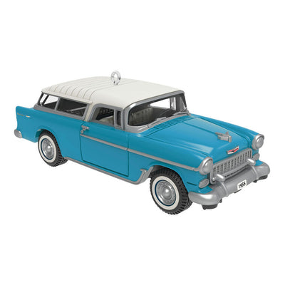 Miniature 1955 Chevrolet Nomad Wagon Christmas ornament in blue and white, featuring vintage styling, turning wheels, and silver accents.
