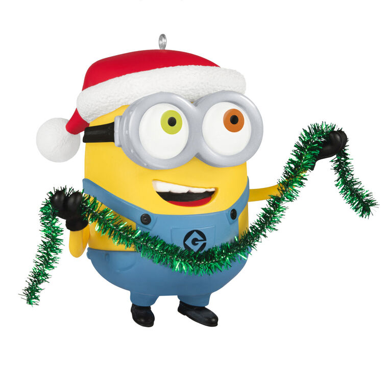 Minion Bob ornament in Santa hat holding green tinsel garland with a big smile