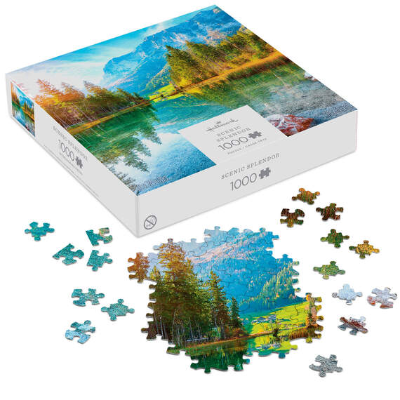 Hallmark Scenic Splendor puzzle featuring a clear lake, evergreen trees, and snow-capped mountain under a bright blue sky.

