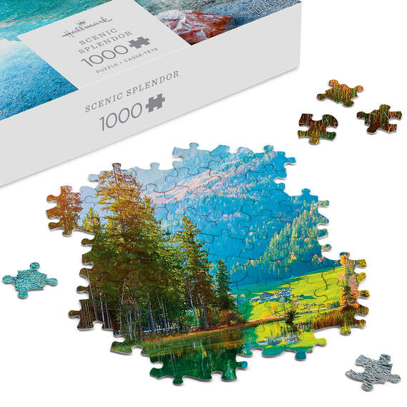 Hallmark Scenic Splendor puzzle featuring a clear lake, evergreen trees, and snow-capped mountain under a bright blue sky.

