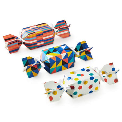 Set of 3 colorful candy-shaped party favor boxes with stripes, dots, and triangle patterns, including white satin ribbon ties
