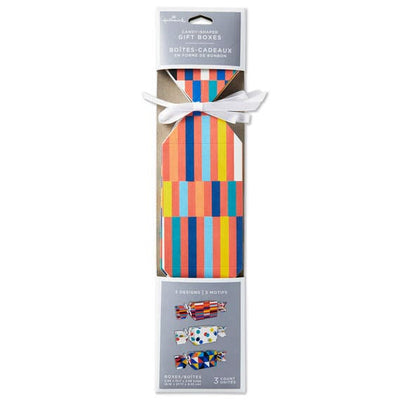 Set of 3 colorful candy-shaped party favor boxes with stripes, dots, and triangle patterns, including white satin ribbon ties
