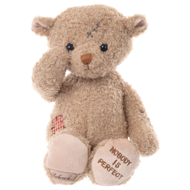 Plush bear with a scar on its head and wound on its side, 11 inches tall, a symbol of resilience and strength.


