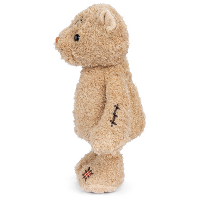 Plush bear with a scar on its head and wound on its side, 11 inches tall, a symbol of resilience and strength, perfect for motivation.

