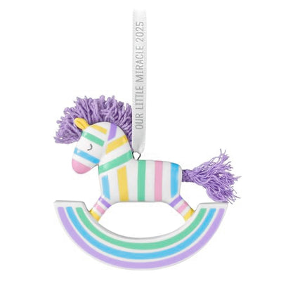 Pastel-striped porcelain rocking horse ornament with lavender yarn mane and tail, hanging by a 2025 ribbon